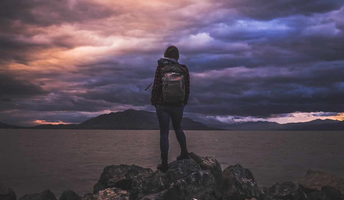 hiker looking across a lake