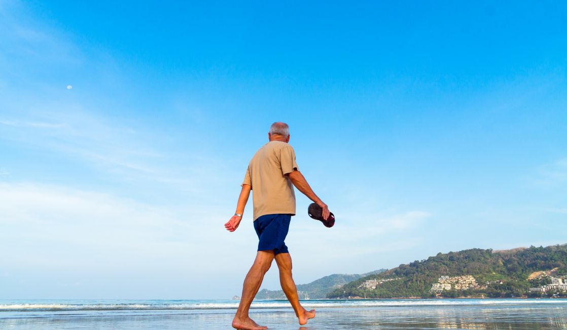 man strolling on a beach