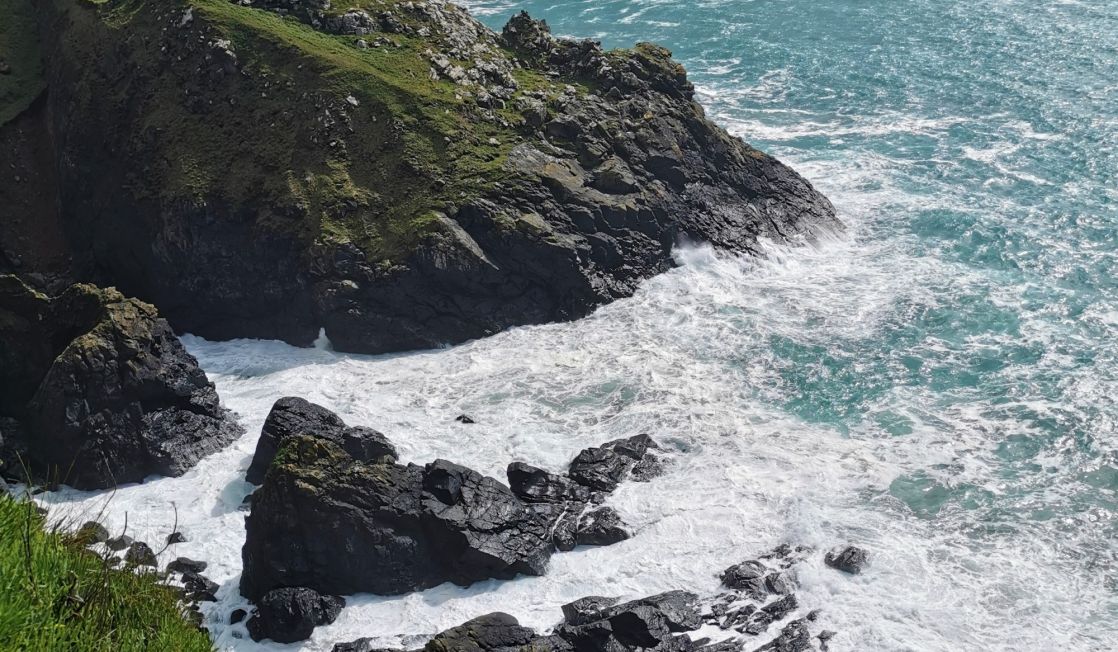 Dark rugged coastline with swirling seas