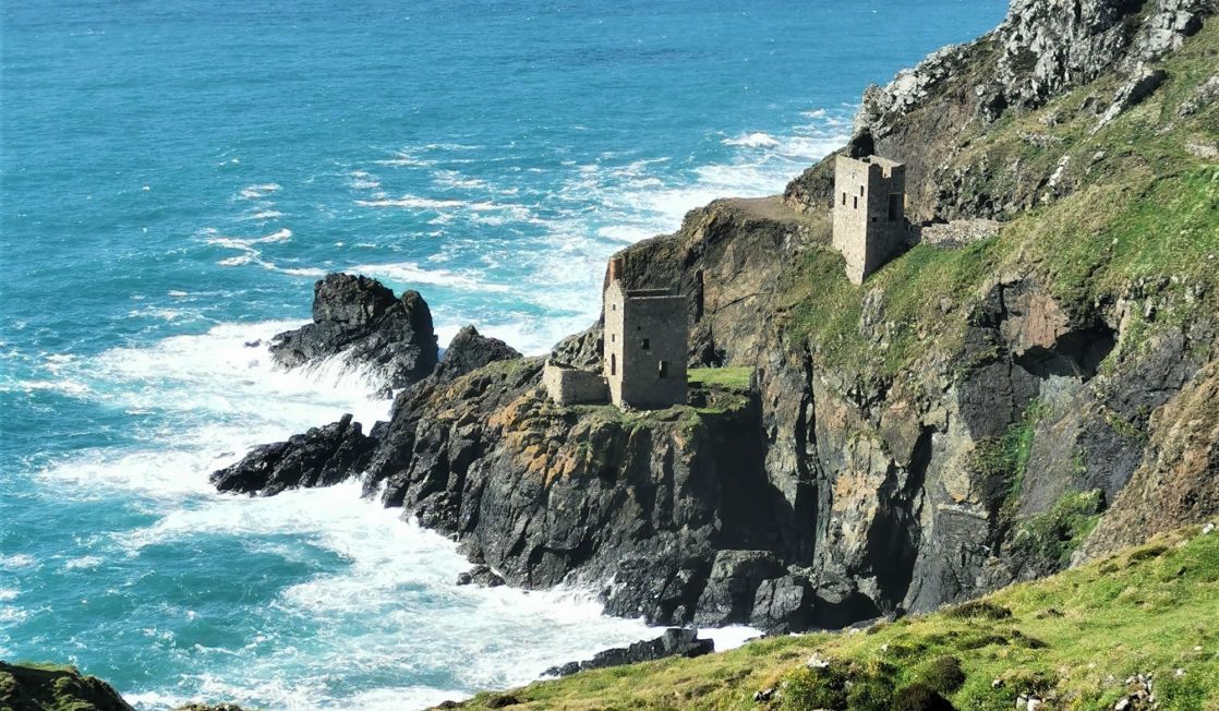 Two mines perched on the cliff edge and blue seas