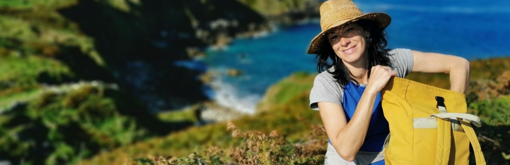 Walker resting on the coast path in Cornwall