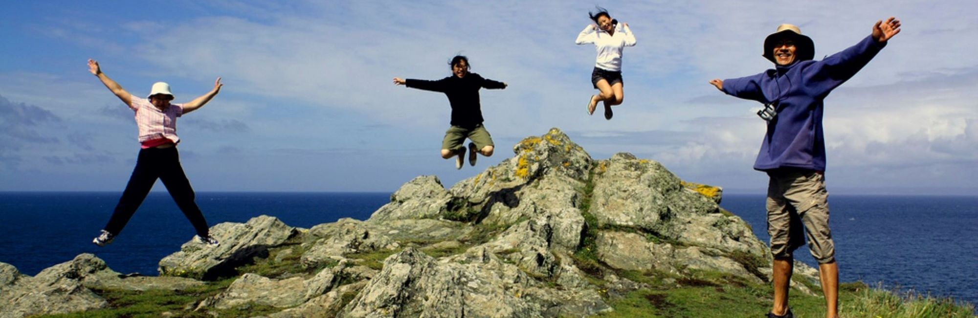 Family jumping at Land's End