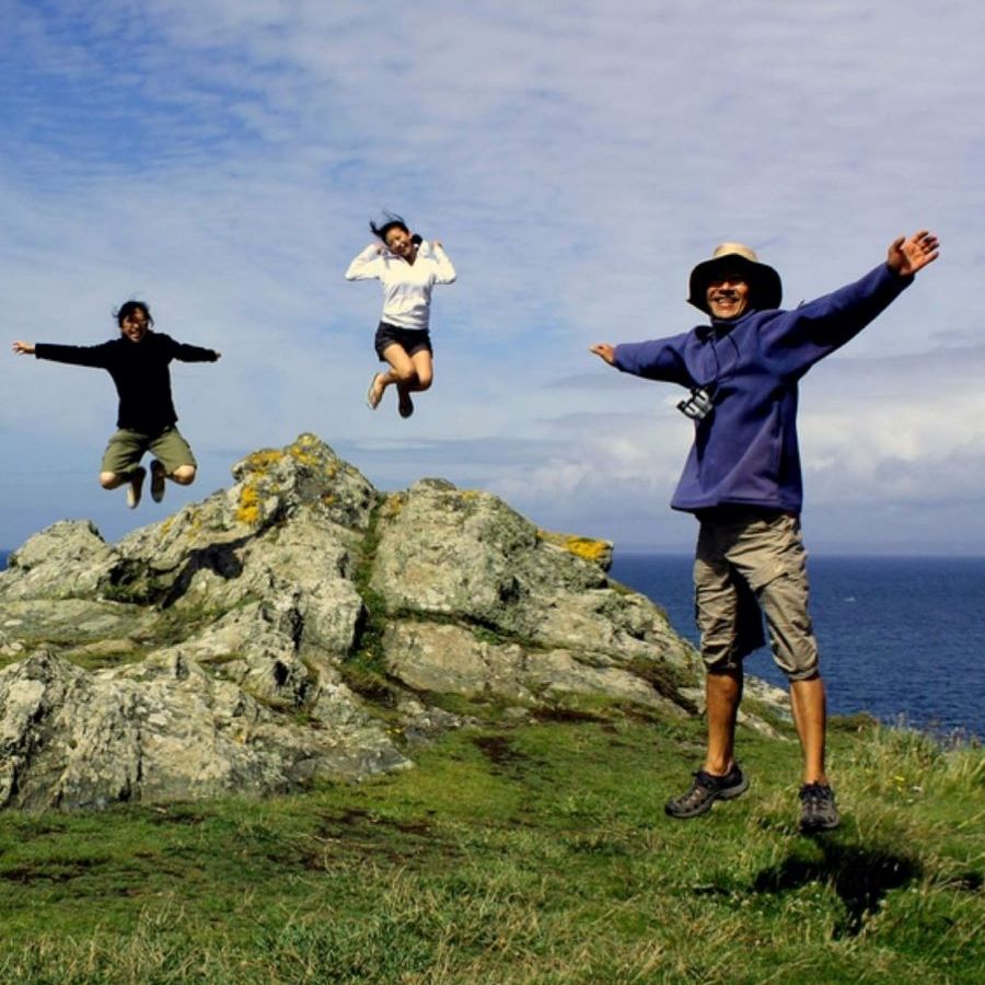 Family jumping at Land's End